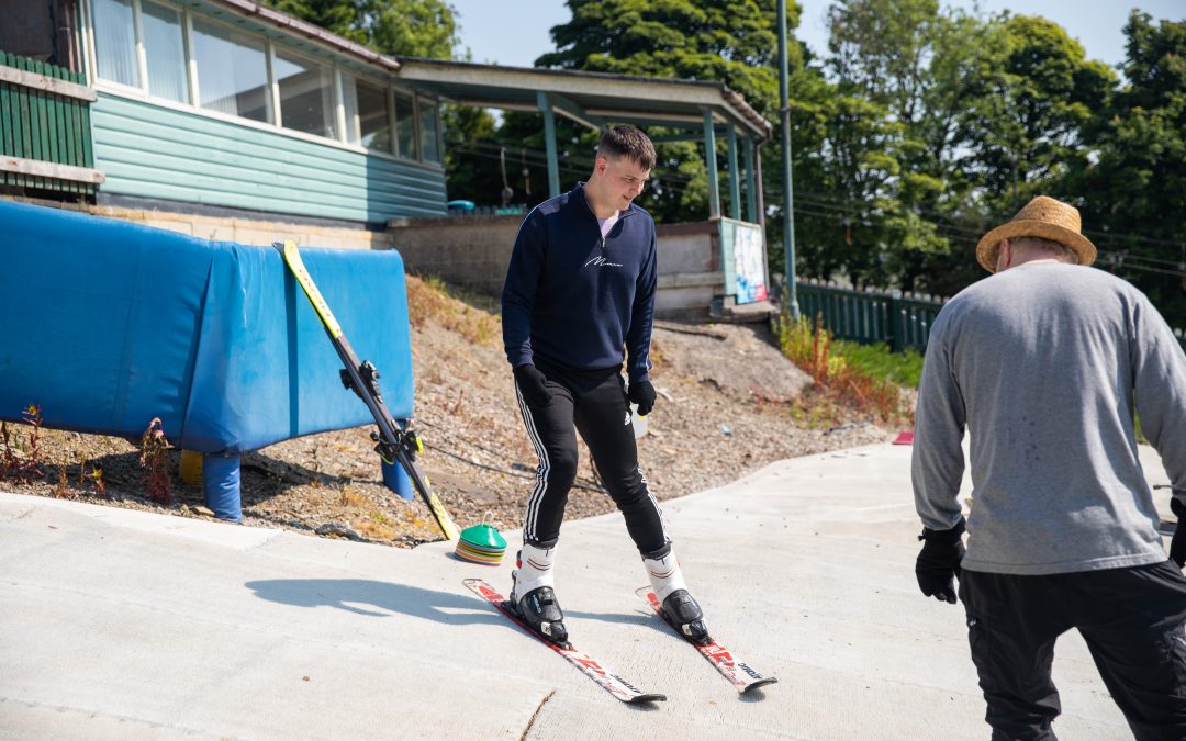 Man on Skis, with Hill instructor on beginner slope ready for private ski lesson