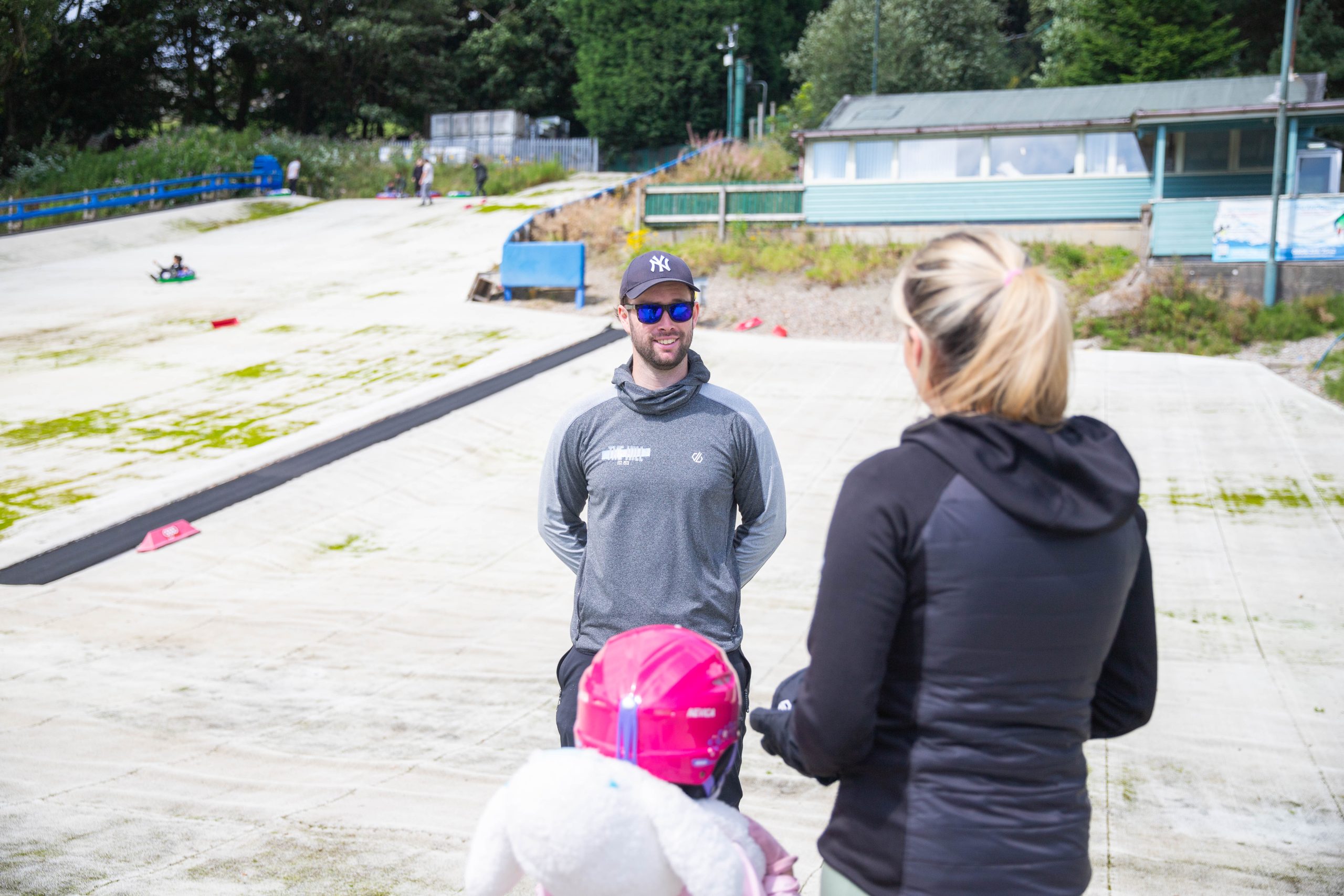 Private ski lesson for family of 5. Mum and daughter on the beginner slope with Ski instructor